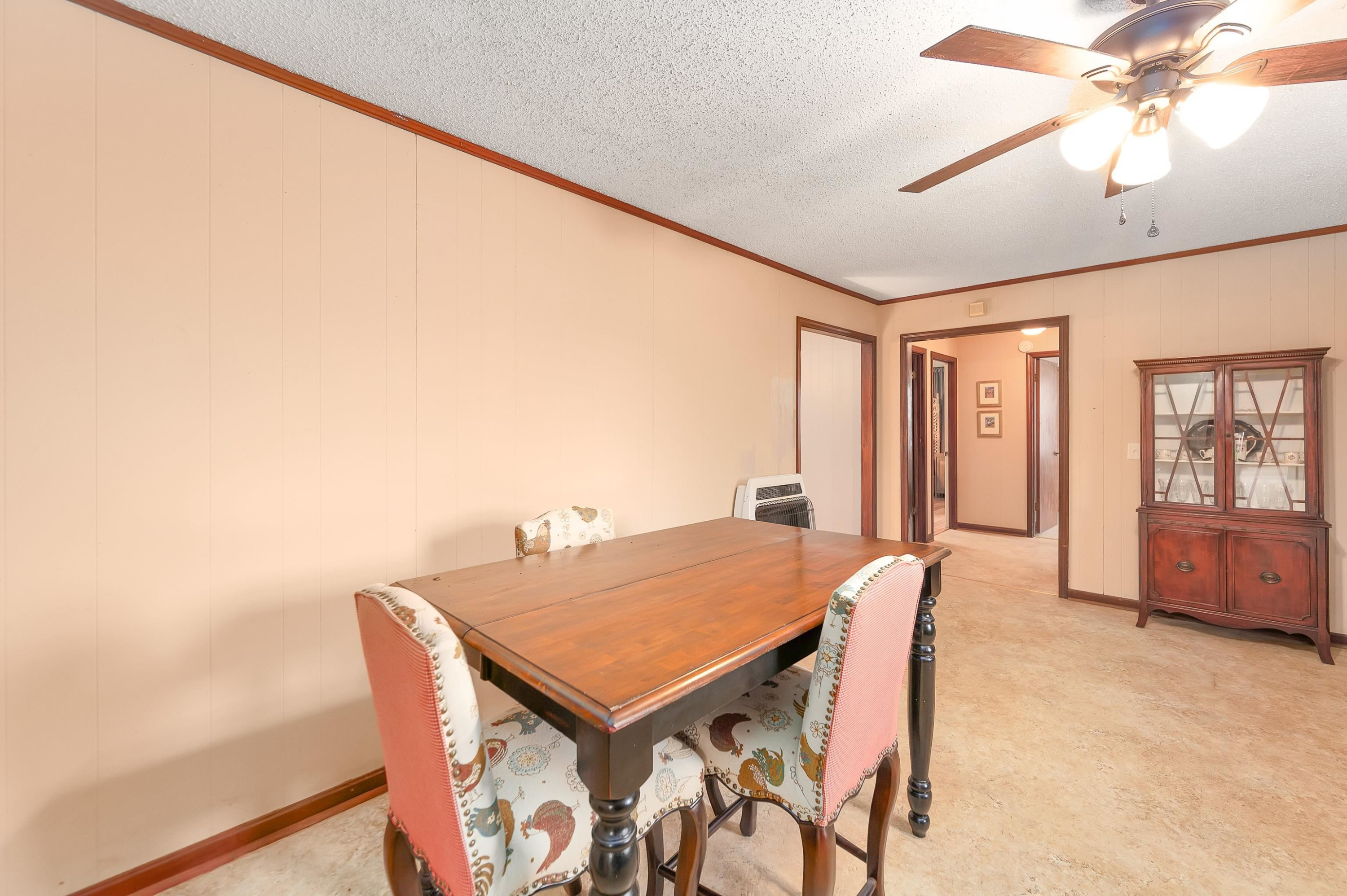 835 Smith Road Luray, TN 38352 - Photo 8 of 19 a view of a dining room with furniture window and wooden floor