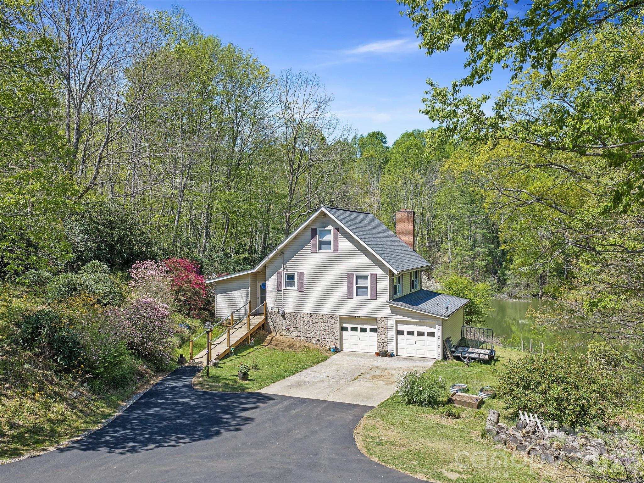 376 Hoot Owl Road Spruce Pine, NC 28777 - Photo 1 of 34 a front view of a house with a yard and garage