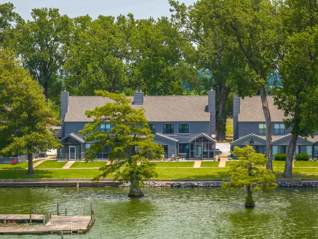 an aerial view of a house with swimming pool and a yard