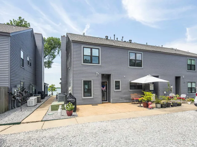 a view of a balcony with floor to ceiling windows and garden