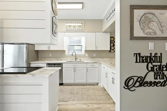 a kitchen with stainless steel appliances granite countertop a refrigerator and a stove