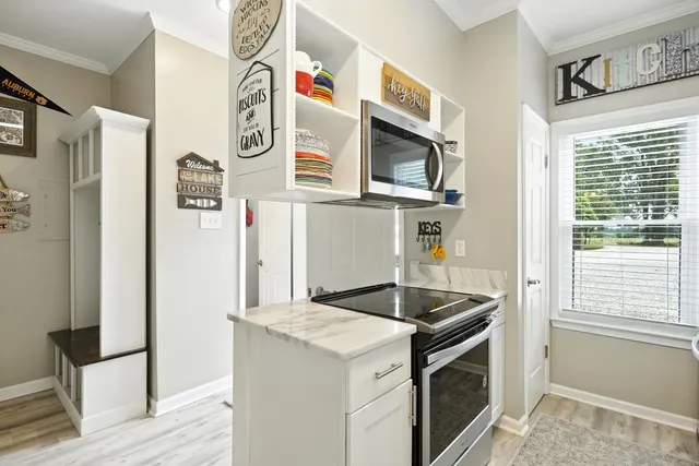 a kitchen with a sink cabinets and window