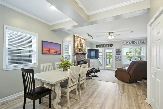 a view of a a dining room with furniture window and wooden floor