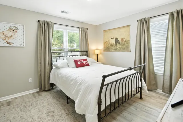 a bedroom with a flat screen tv and a bed