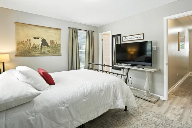 a bathroom with a granite countertop sink mirror vanity and toilet