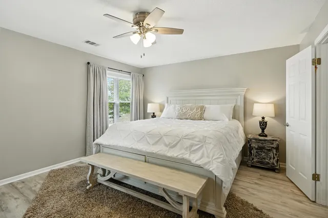 a bedroom with a flat screen tv and a bed