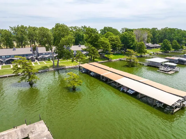 a view of a lake with houses swimming pool and mountain view