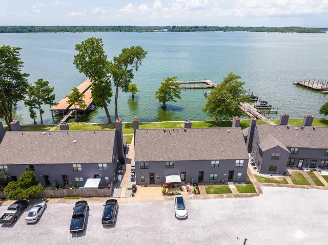 an aerial view of houses with outdoor space and lake view