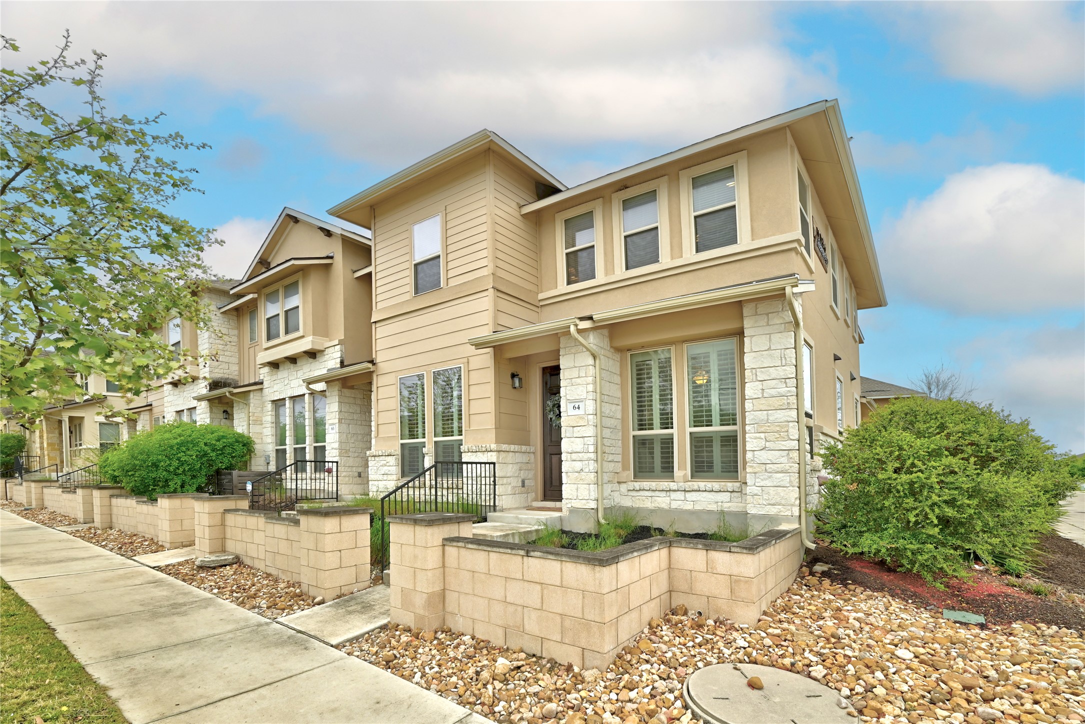 6814 East Riverside Drive, Unit 64 Austin, TX 78741 - Photo 1 of 17 A striking contemporary townhome, featuring a harmonious blend of stone and siding, offers welcoming curb appeal.