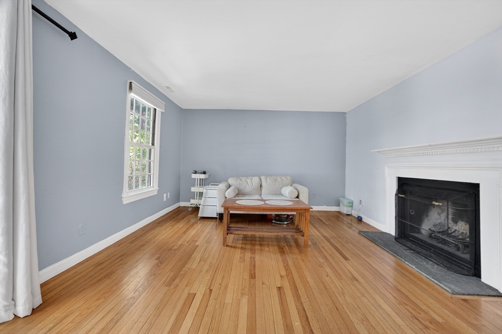 68 Jericho Road, Unit 68 Weston, MA 02493 - Photo 2 of 25 a spacious bedroom with a bed and a fireplace