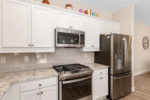 a bedroom with a bed a chandelier and a window