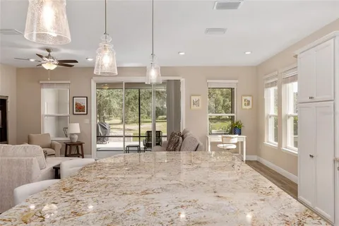 a bedroom with a bed and a ceiling fan