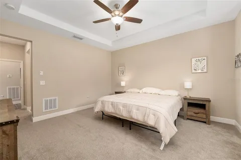 a bedroom with a bed and a ceiling fan