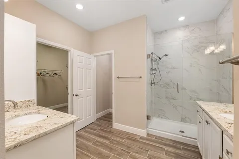 a spacious bedroom with a bed and a ceiling fan