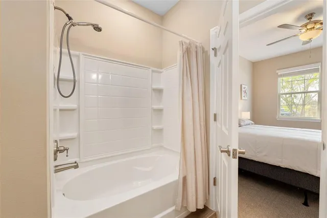 a view of a livingroom with furniture and floor to ceiling window