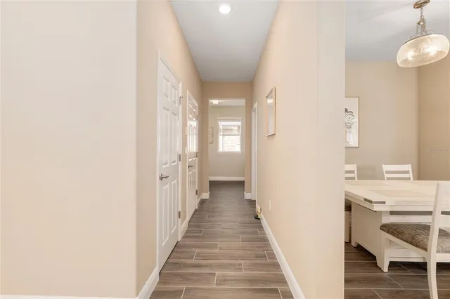 a view of a house with backyard sitting area and swimming pool