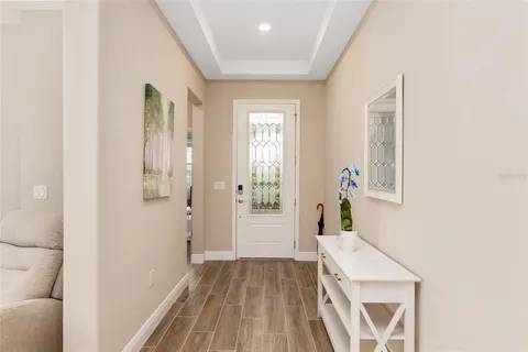 a living room with furniture a flat screen tv and a window