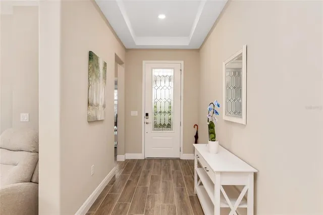 a living room with furniture a flat screen tv and a window