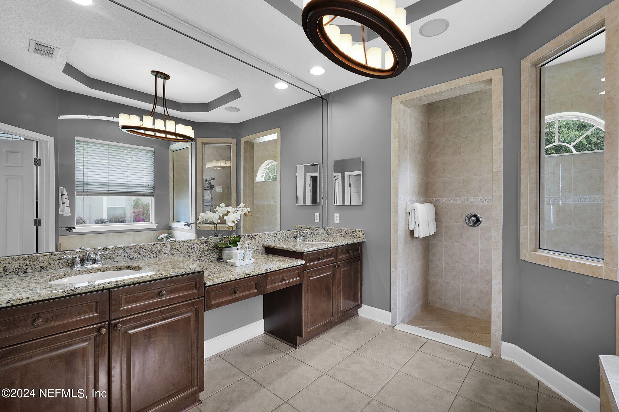 2024 River's Own Road St. Augustine, FL 32092 - Photo 35 of 73 a bathroom with a granite countertop sink a mirror and a shower
