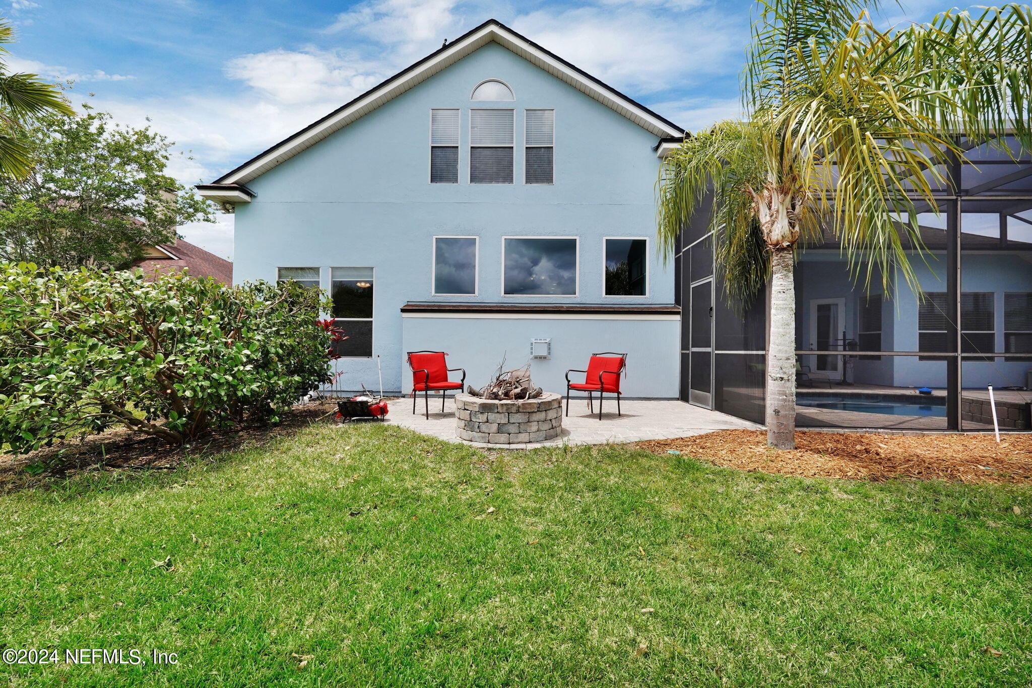 2024 River's Own Road St. Augustine, FL 32092 - Photo 54 of 73 a view of a white house with table and chairs and potted plants