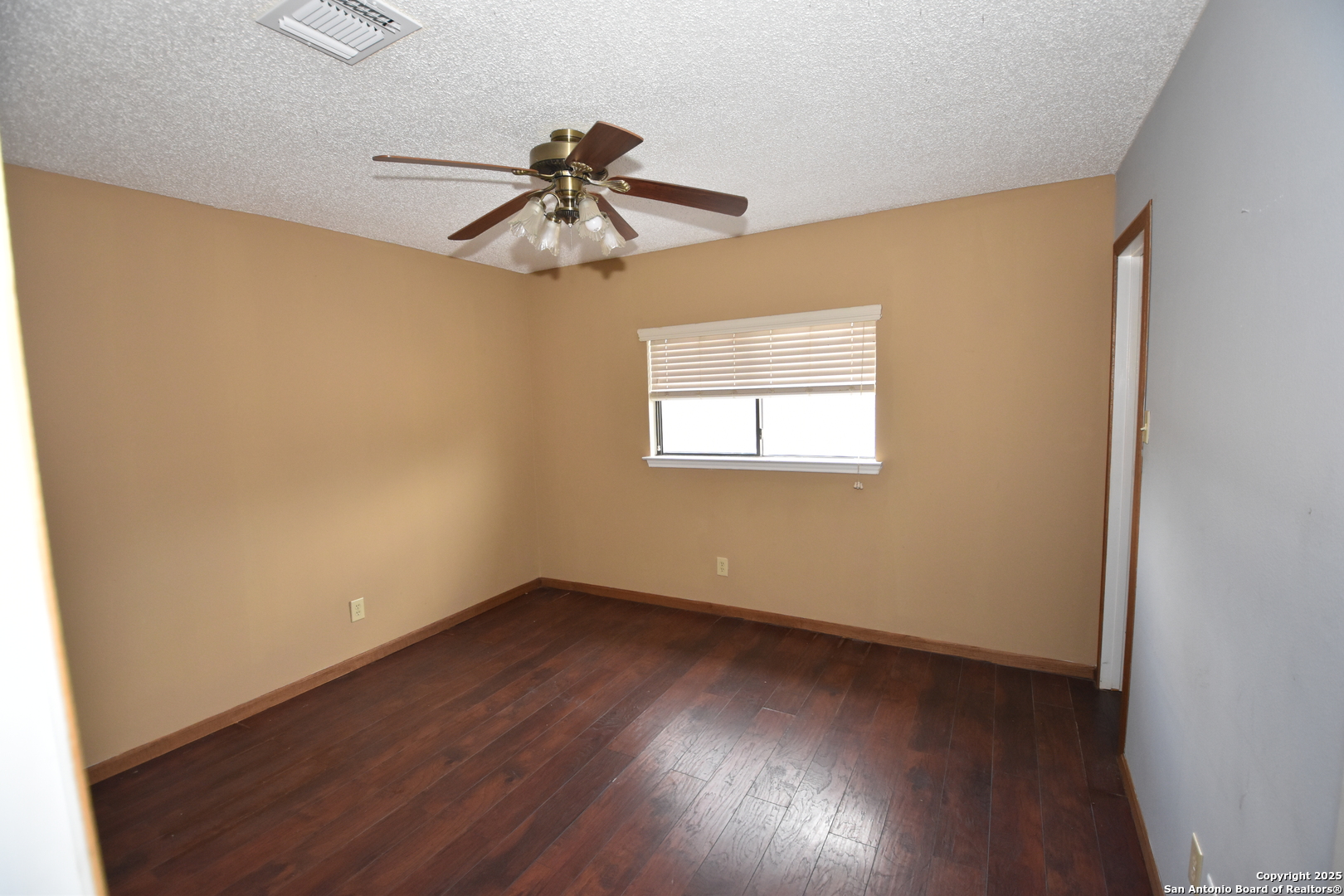 1607 Pinetum Drive San Antonio, TX 78213 - Photo 20 of 26 an empty room with wooden floor fan and windows