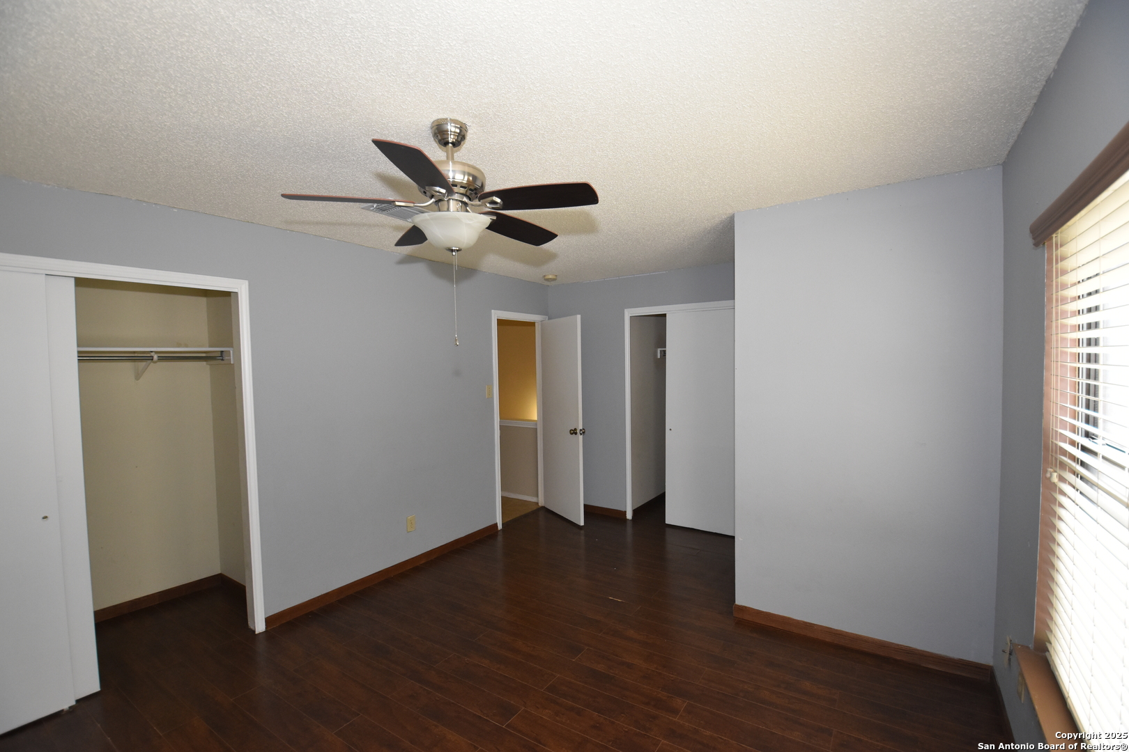 1607 Pinetum Drive San Antonio, TX 78213 - Photo 22 of 26 a view of an empty room with wooden floor and a window