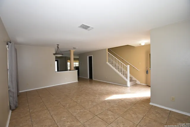 a view of a big room with closet and windows