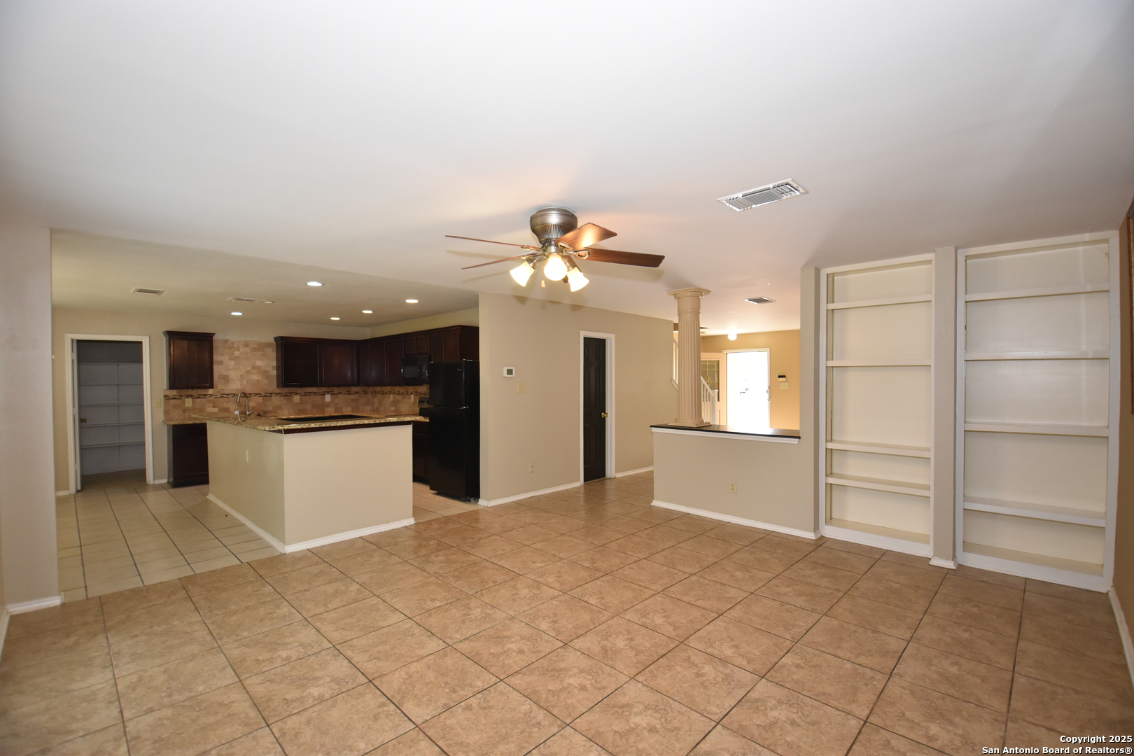 1607 Pinetum Drive San Antonio, TX 78213 - Photo 4 of 26 a kitchen with a refrigerator and white cabinets