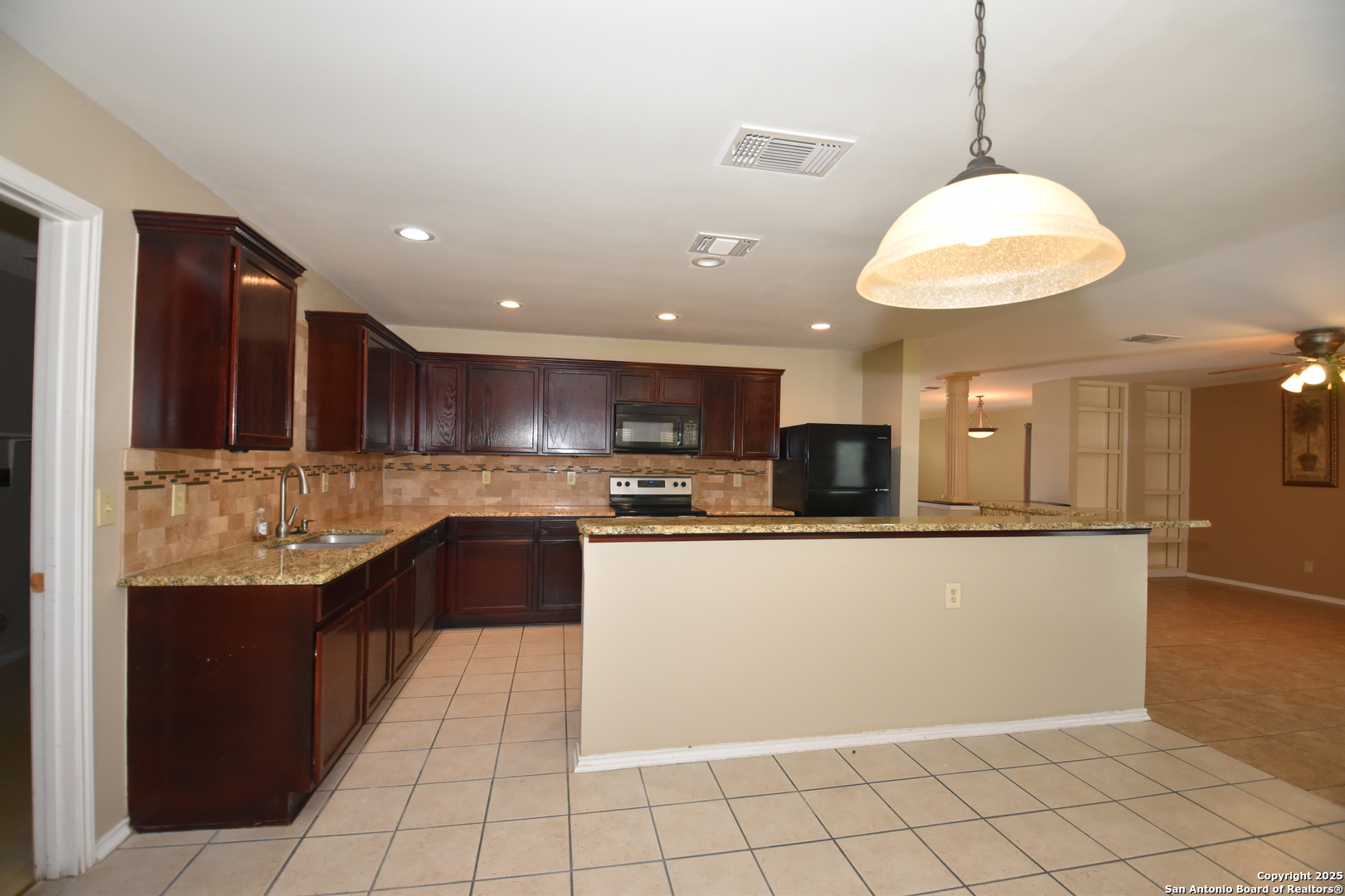 1607 Pinetum Drive San Antonio, TX 78213 - Photo 10 of 26 a kitchen with stainless steel appliances granite countertop a refrigerator a sink and a stove