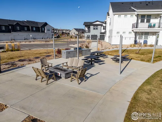 an aerial view of a swimming pool with outdoor seating and city view
