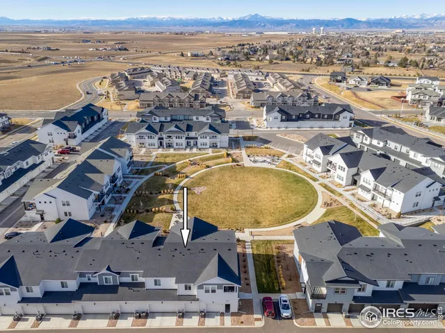 an aerial view of a swimming pool with a lake view