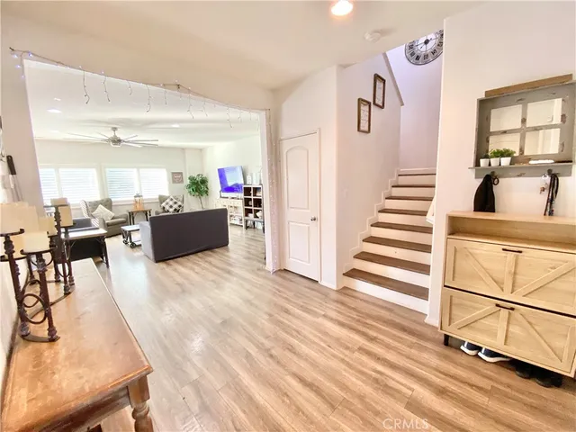 a kitchen with kitchen island granite countertop a sink cabinets and wooden floor