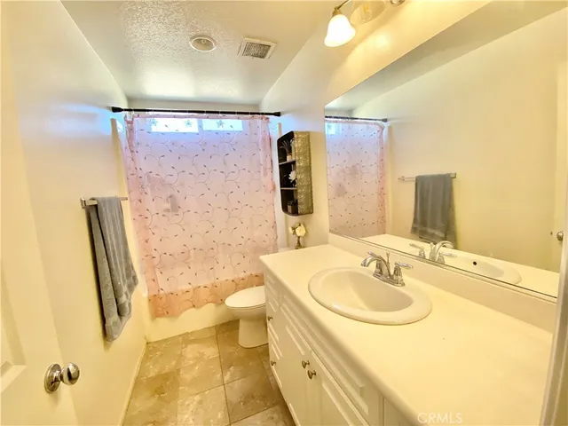 a bedroom with a bed and a chair