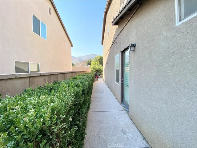 a view of a terrace with chairs and potted plants