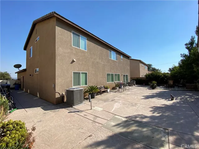 a backyard of a house with yard and outdoor seating