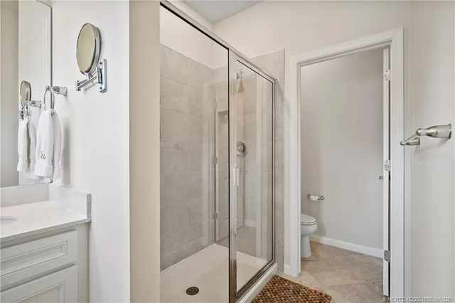a bathroom with a double vanity sink toilet and shower