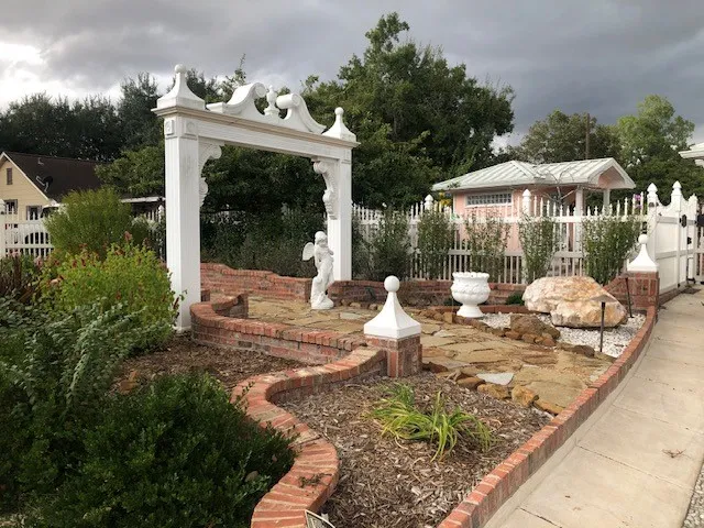 a view of backyard with swimming pool and green space