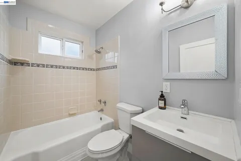 an empty room with window and ceiling fan