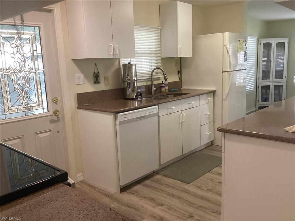 15 Cannes Drive Naples, FL 34112 - Photo 11 of 33 a kitchen with stainless steel appliances granite countertop a sink stove and refrigerator
