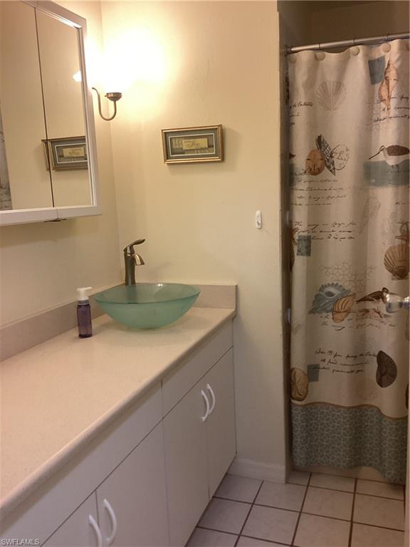 15 Cannes Drive Naples, FL 34112 - Photo 18 of 33 a bathroom with a sink and a mirror