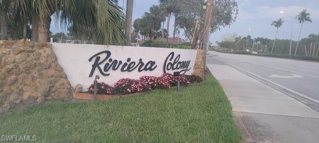 15 Cannes Drive Naples, FL 34112 - Photo 23 of 33 a sign on the side of the road