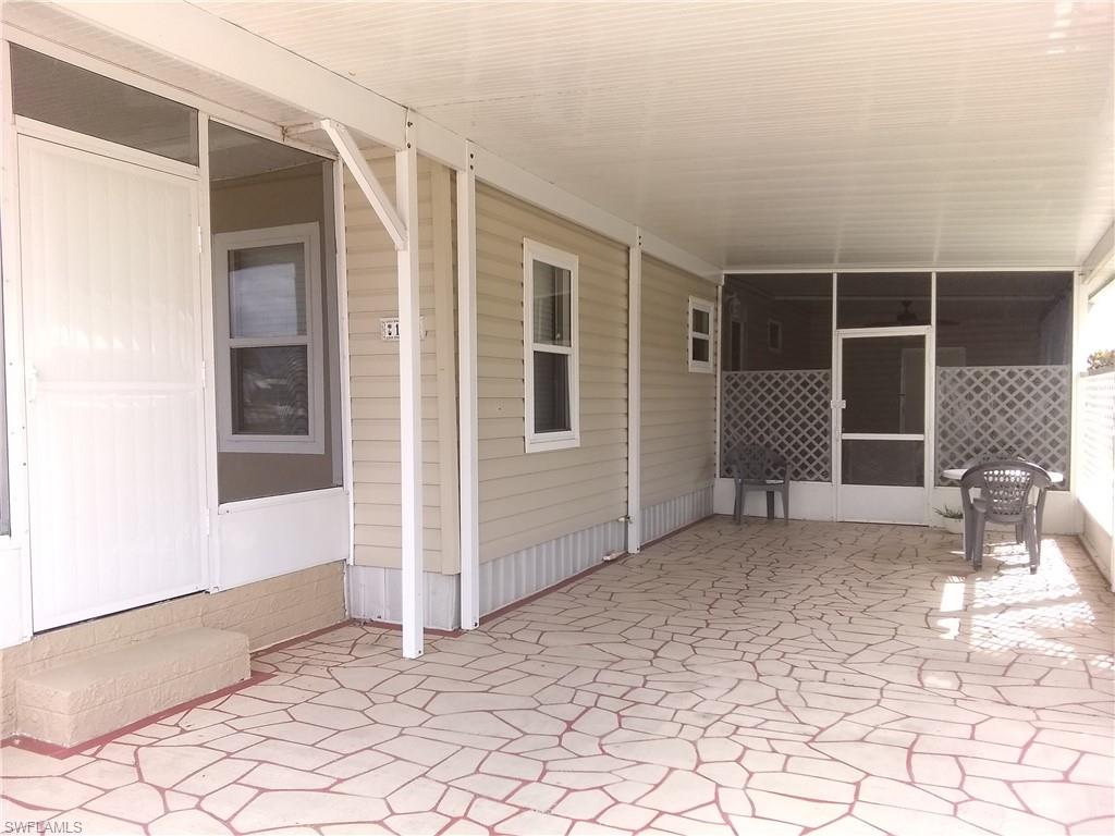 15 Cannes Drive Naples, FL 34112 - Photo 31 of 33 a view of a house with backyard and sitting area