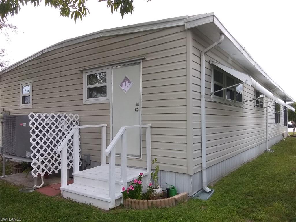 15 Cannes Drive Naples, FL 34112 - Photo 33 of 33 a front view of a house with garden