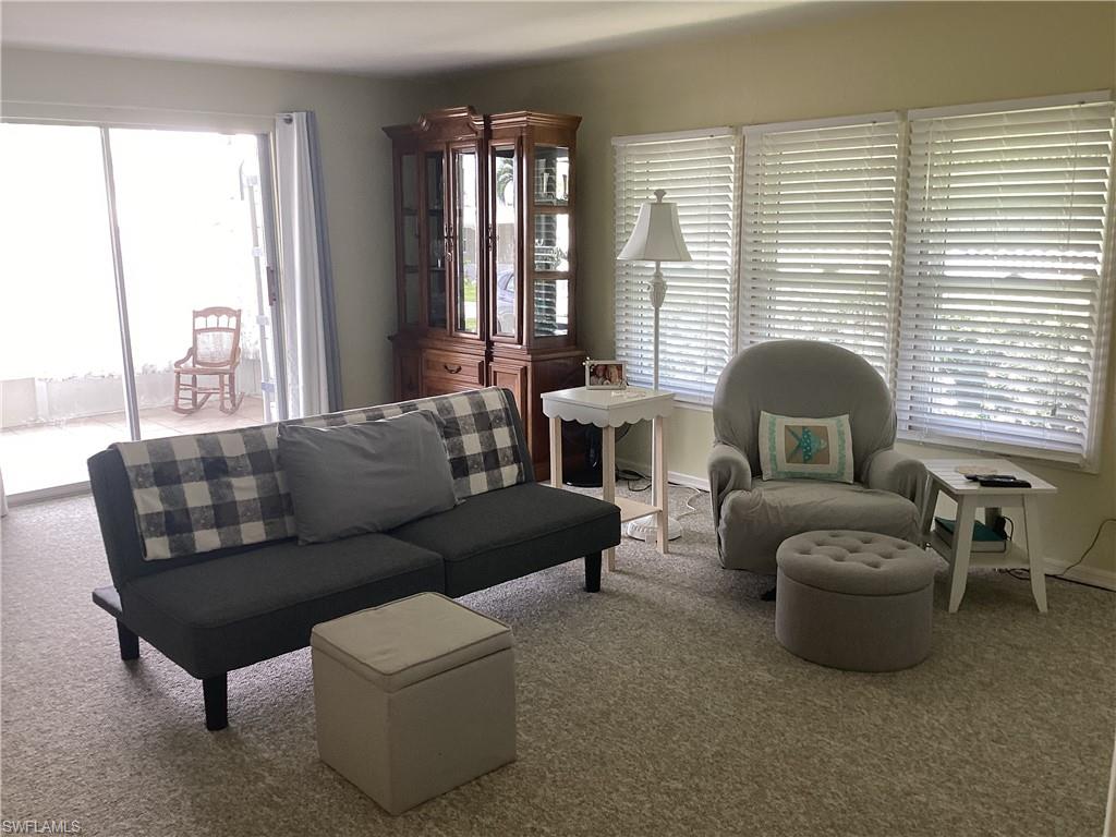 15 Cannes Drive Naples, FL 34112 - Photo 4 of 33 a living room with furniture and a large window