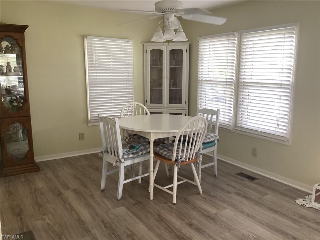 15 Cannes Drive Naples, FL 34112 - Photo 6 of 33 a dining room with furniture window and wooden floor
