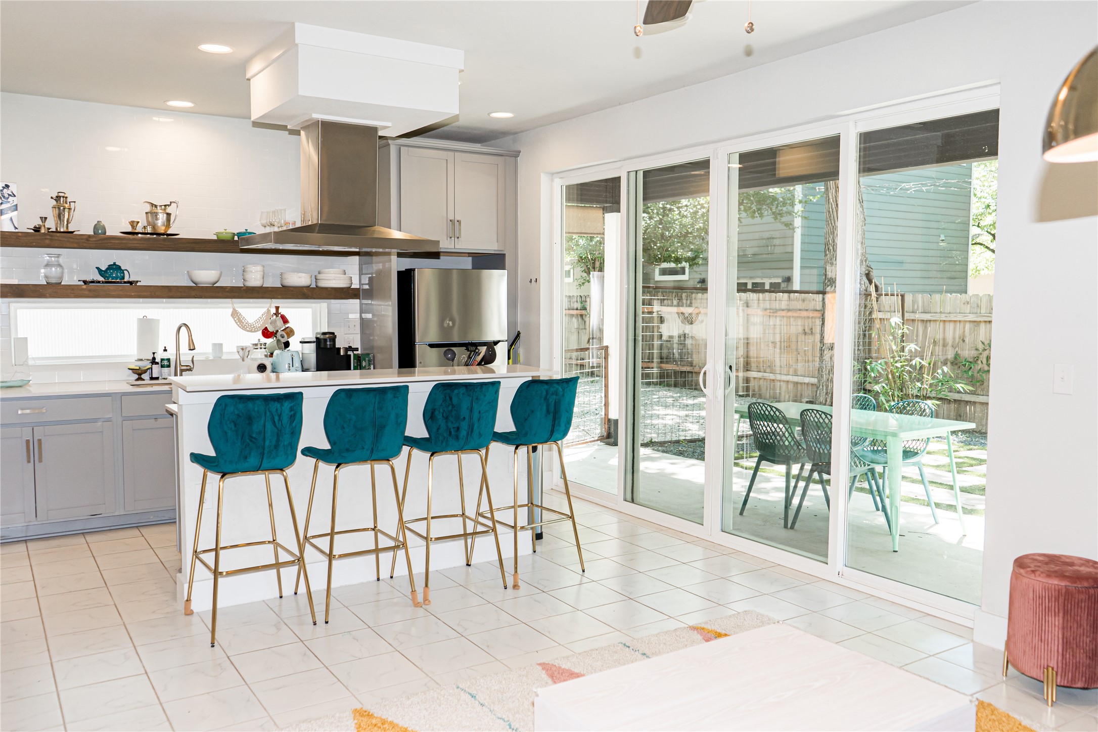 2714 East 3rd Street, Unit 2 Austin, TX 78702 - Photo 1 of 13 a kitchen with stainless steel appliances kitchen island granite countertop a table and chairs in it