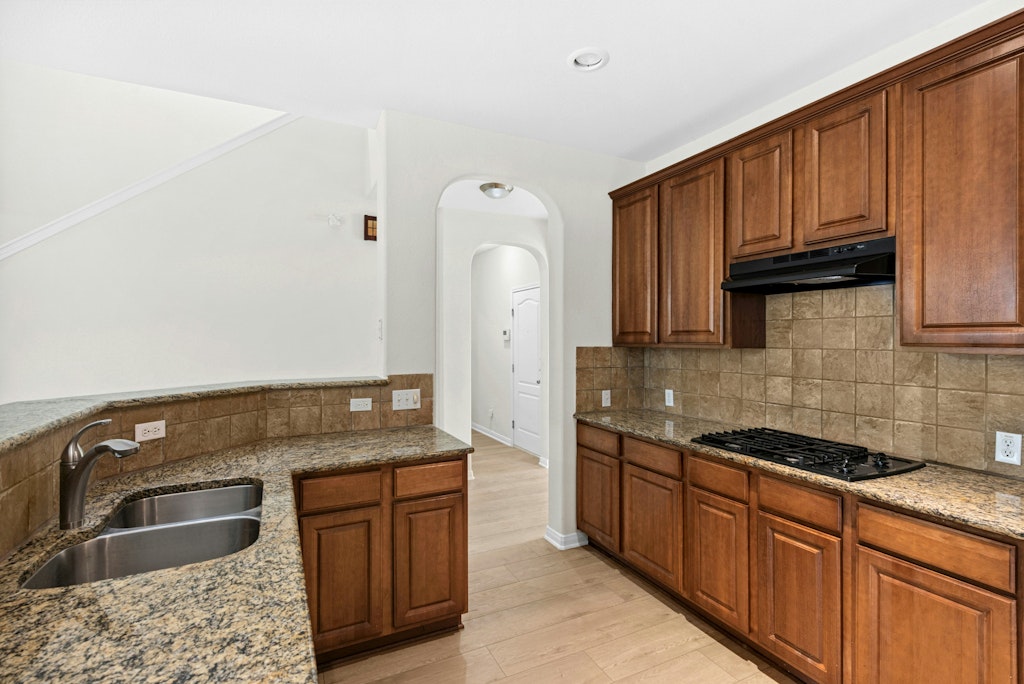 903 Fork Ridge Path Round Rock, TX 78665 - Photo 12 of 35 a kitchen with stainless steel appliances granite countertop a sink stove and cabinets