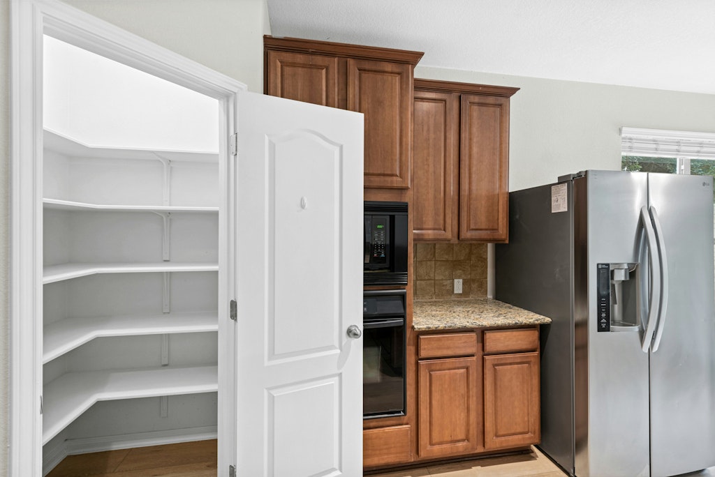 903 Fork Ridge Path Round Rock, TX 78665 - Photo 14 of 35 a kitchen with stainless steel appliances granite countertop a refrigerator and a stove