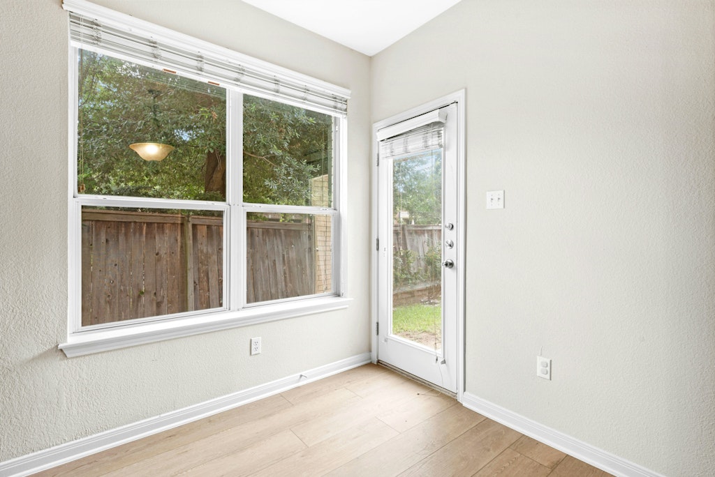 903 Fork Ridge Path Round Rock, TX 78665 - Photo 15 of 35 an empty room with wooden floor and windows