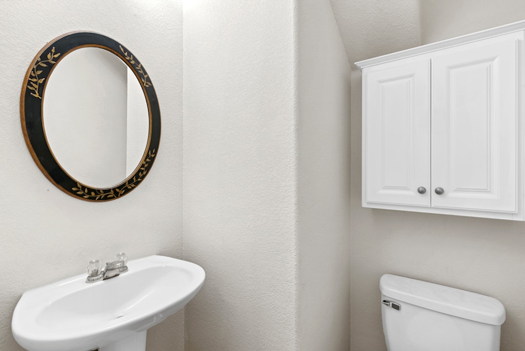 903 Fork Ridge Path Round Rock, TX 78665 - Photo 16 of 35 a bathroom with a sink and a mirror